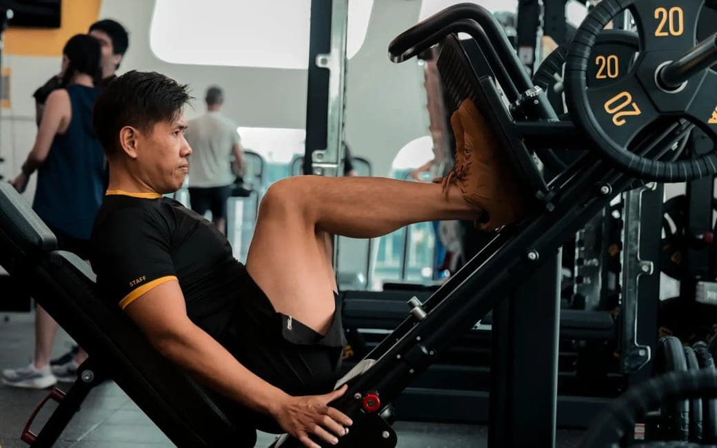 Strength training session on a leg press machine in a gym